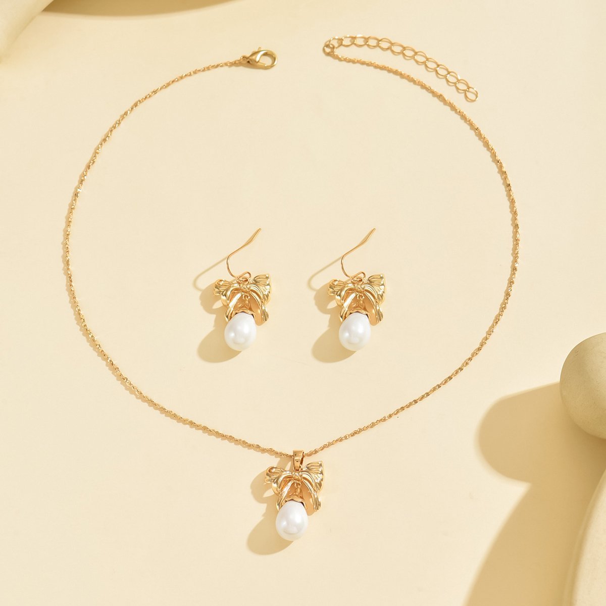 Elegant Gold-Toned Bow & Pearl Jewelry Set - Necklace & Earrings - Image 3