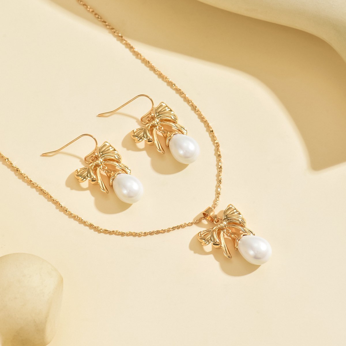 Elegant Gold-Toned Bow & Pearl Jewelry Set - Necklace & Earrings - Image 2